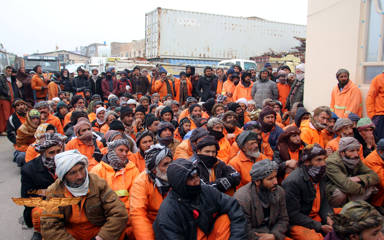 Distribution of food items to the orange-clad Herat Municipality by a charity